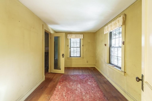 unfurnished room with dark wood-type flooring