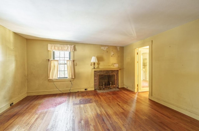 unfurnished living room featuring a fireplace and hardwood / wood-style floors