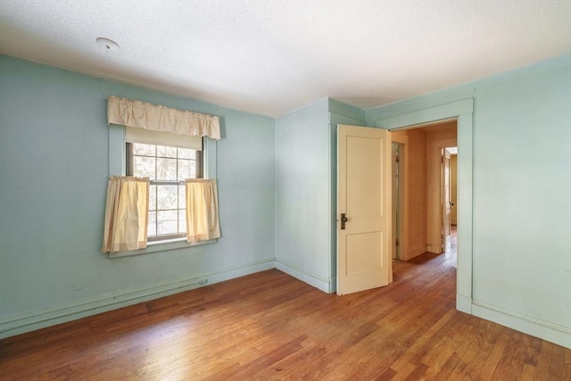 spare room with hardwood / wood-style flooring