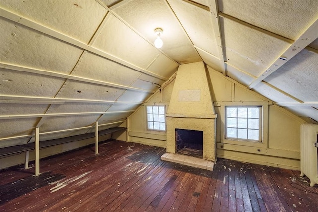 bonus room with dark hardwood / wood-style flooring, a fireplace, and lofted ceiling