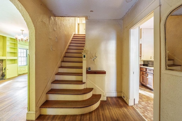 staircase with wood-type flooring