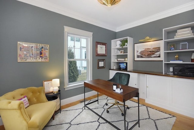 office space featuring light wood-type flooring, baseboards, and ornamental molding