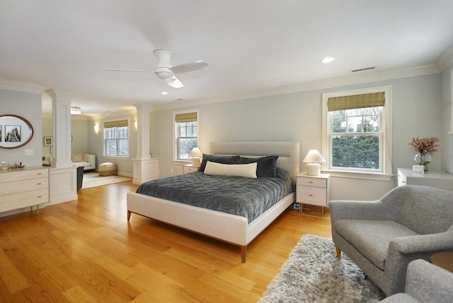 bedroom with ornamental molding, decorative columns, visible vents, and light wood-type flooring