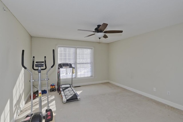 exercise area featuring light carpet and ceiling fan