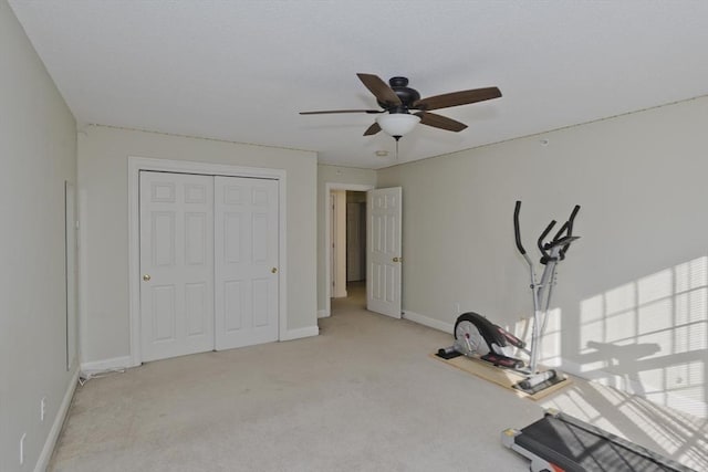 workout room with light colored carpet and ceiling fan