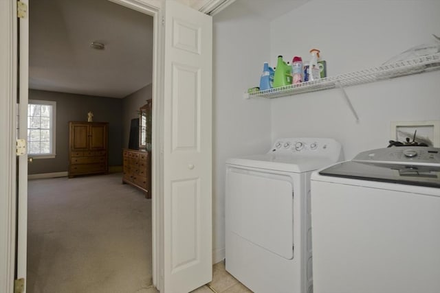 clothes washing area with washer and dryer and light carpet