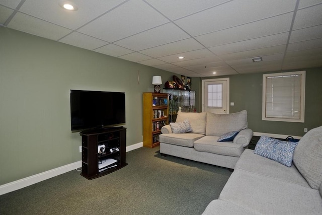 carpeted living room featuring a drop ceiling