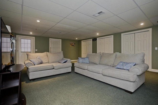 living room with carpet floors and a drop ceiling