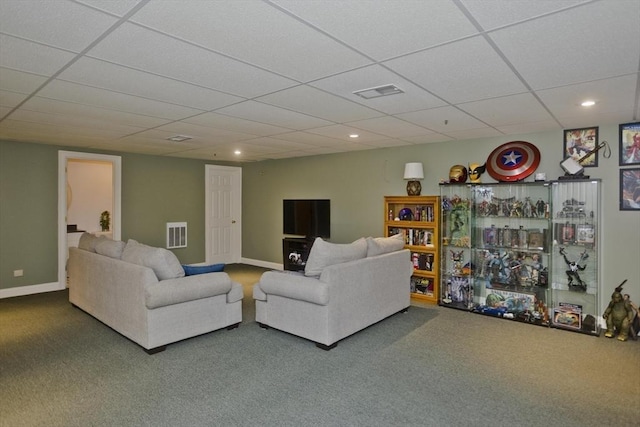 living room with carpet flooring and a drop ceiling