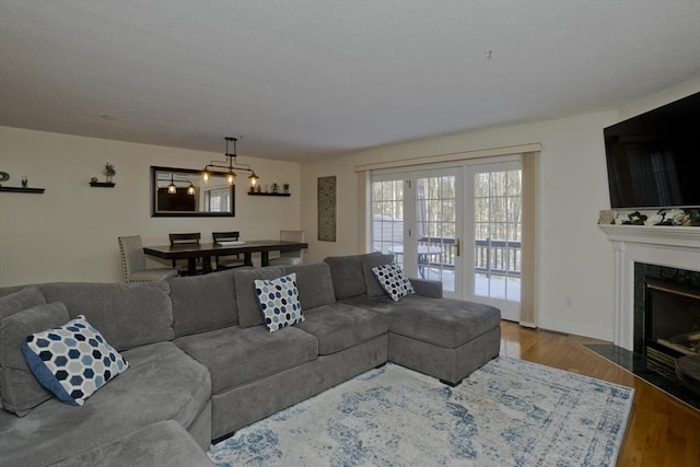 living room featuring a high end fireplace and wood-type flooring