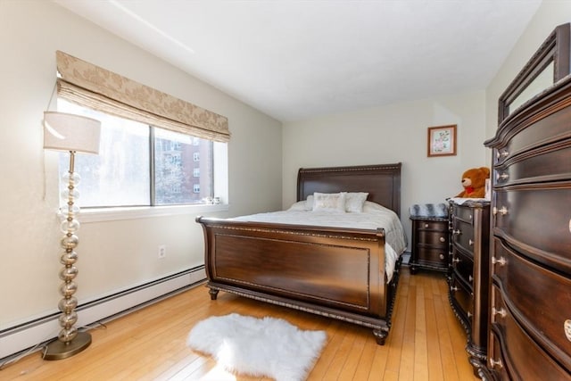115 Highland Ave Unit 21, Somerville, MA 02143 - bedroom featuring a baseboard radiator and hardwood / wood-style flooring