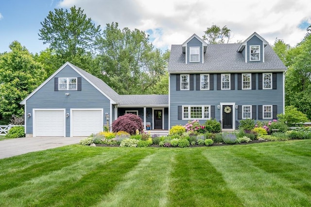21 Boutwell, Andover, MA 01810 - colonial house with a front yard, driveway, covered porch, an attached garage, and roof with shingles
