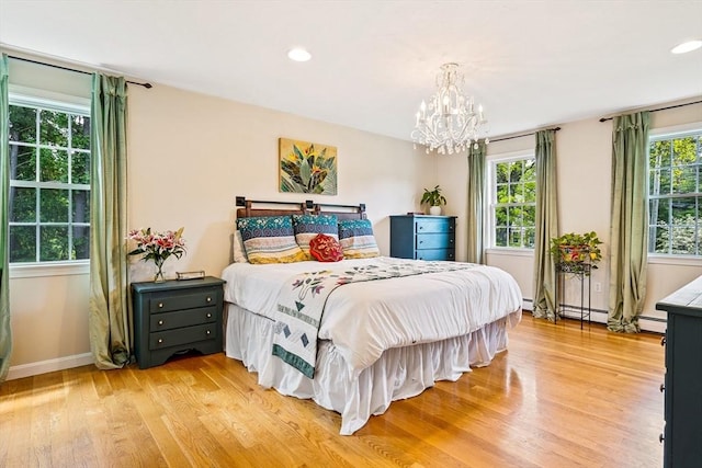 21 Boutwell, Andover, MA 01810 - bedroom featuring light wood-type flooring, a chandelier, recessed lighting, and a baseboard radiator