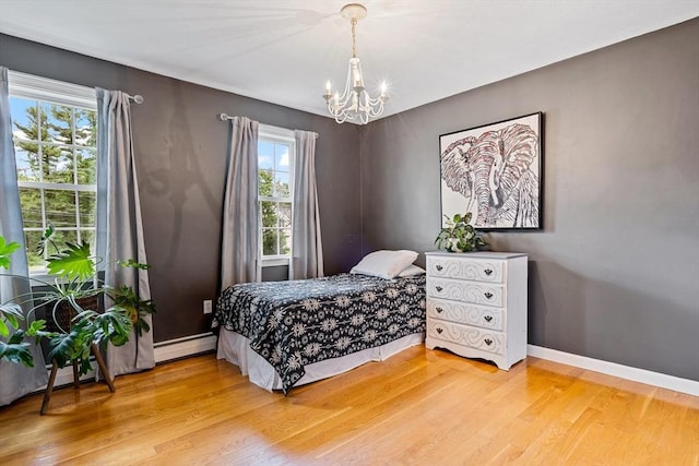 21 Boutwell, Andover, MA 01810 - bedroom with a chandelier, wood finished floors, and a baseboard heating unit