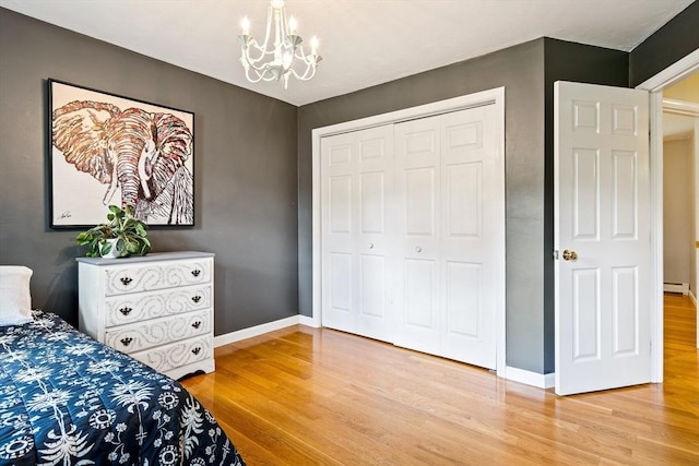 21 Boutwell, Andover, MA 01810 - bedroom with light wood-type flooring, a chandelier, a closet, and a baseboard radiator