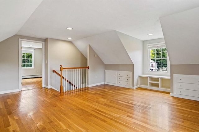 21 Boutwell, Andover, MA 01810 - additional living space with vaulted ceiling, light wood finished floors, a baseboard radiator, and plenty of natural light