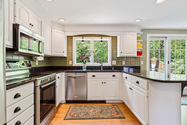 21 Boutwell, Andover, MA 01810 - kitchen featuring appliances with stainless steel finishes, a peninsula, plenty of natural light, white cabinetry, and recessed lighting