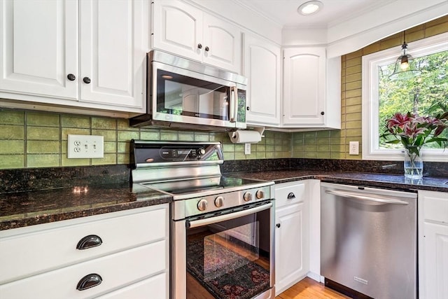 21 Boutwell, Andover, MA 01810 - kitchen featuring appliances with stainless steel finishes, crown molding, white cabinetry, and tasteful backsplash
