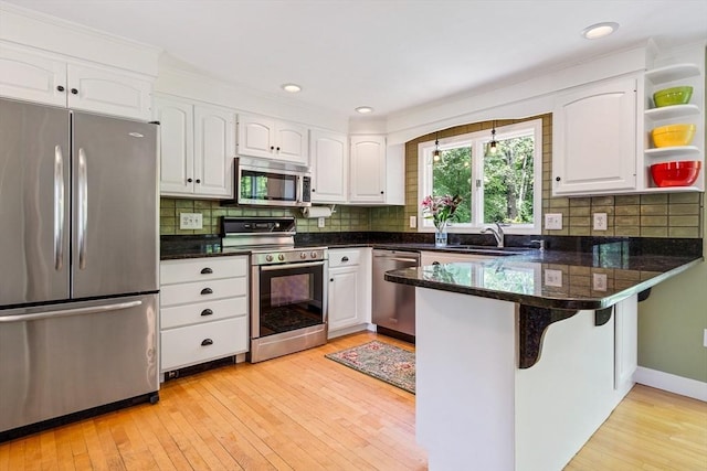 21 Boutwell, Andover, MA 01810 - kitchen with stainless steel appliances, white cabinetry, a peninsula, light wood-style flooring, and recessed lighting