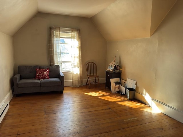 additional living space featuring wood-type flooring, a baseboard radiator, and vaulted ceiling