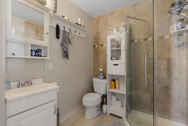 full bath featuring vanity, tile patterned flooring, a shower stall, and toilet