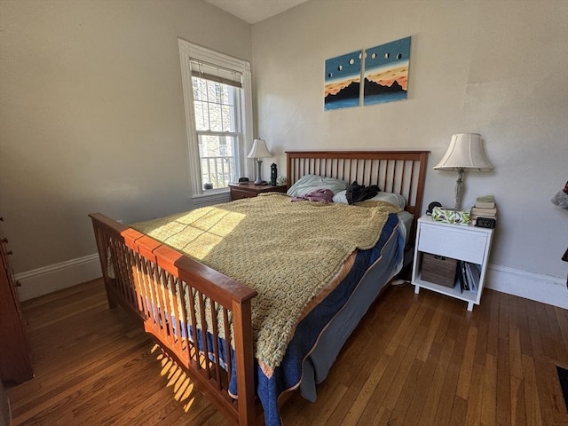 bedroom featuring baseboards and hardwood / wood-style floors
