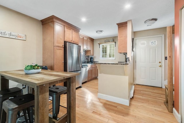 9 Adam St Unit 12, Easton, MA 02375 - kitchen featuring appliances with stainless steel finishes, light wood finished floors, baseboards, and tasteful backsplash