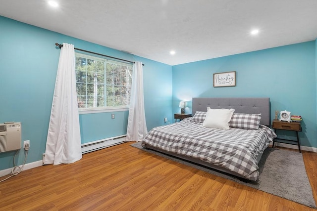 9 Adam St Unit 12, Easton, MA 02375 - bedroom featuring baseboard heating, wood finished floors, recessed lighting, baseboards, and a wall mounted AC