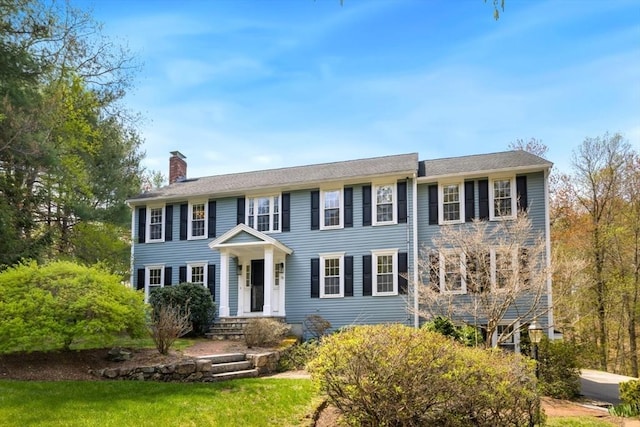 colonial inspired home featuring a chimney