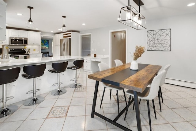 dining space with light tile patterned floors, a baseboard heating unit, and recessed lighting