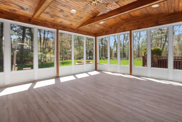 unfurnished sunroom featuring beam ceiling and ceiling fan