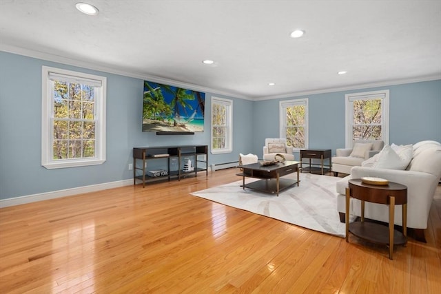 living room featuring crown molding, light wood-style floors, baseboard heating, and recessed lighting