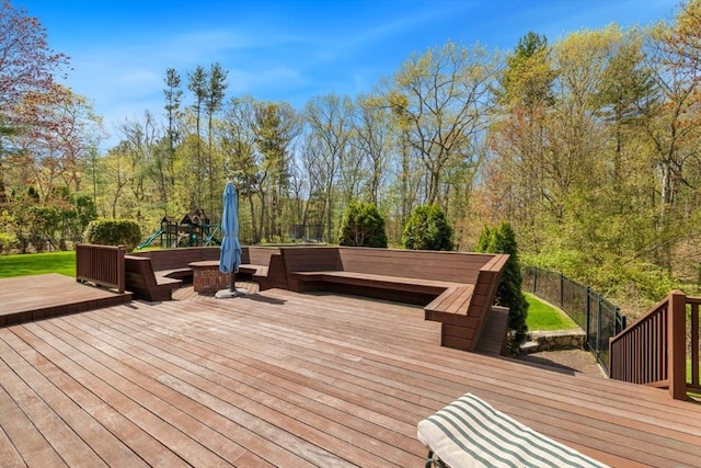 deck with fence and a forest view