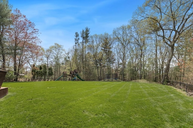 view of yard with fence and a playground