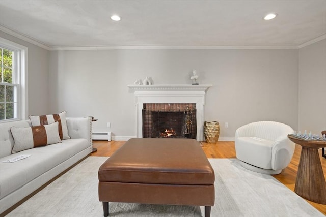 living room featuring wood finished floors, baseboard heating, ornamental molding, and recessed lighting