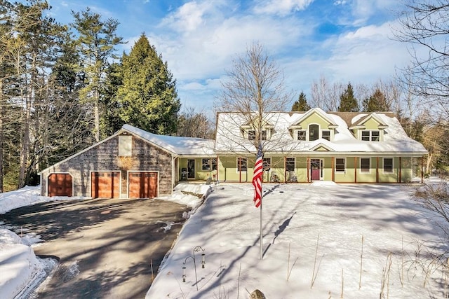 cape cod-style house with a porch and driveway