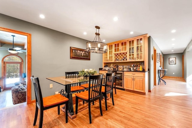 dining space featuring ceiling fan, wine cooler, recessed lighting, indoor bar, and light wood-style floors