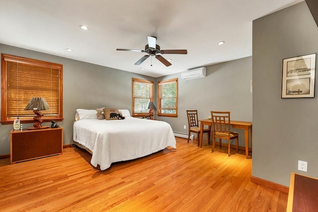 bedroom with light wood finished floors, recessed lighting, baseboards, and a wall mounted air conditioner