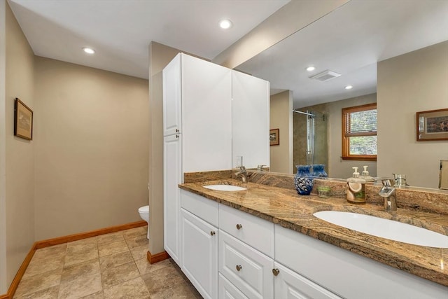 full bath with visible vents, a sink, a shower stall, and toilet