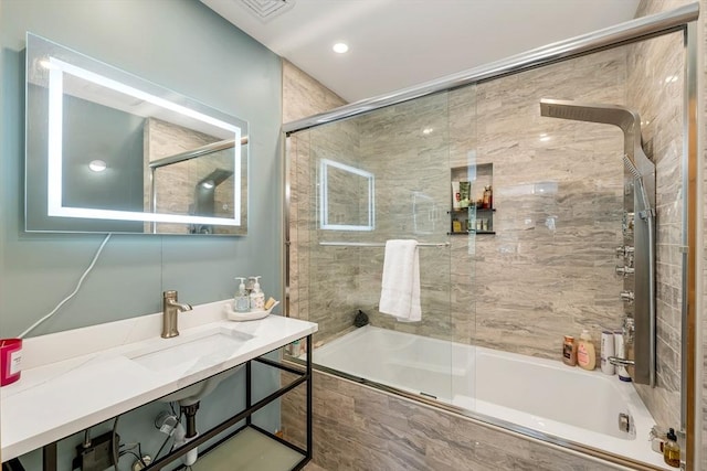 full bathroom with tiled shower / bath and a sink