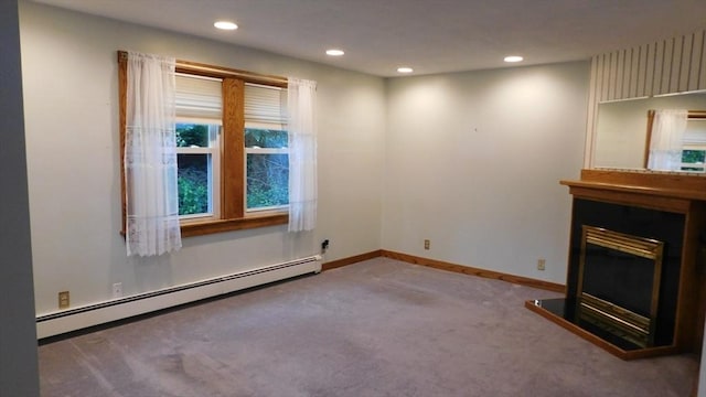 414 Cedar St, Dedham, MA 02026 - unfurnished living room featuring baseboard heating, carpet, a glass covered fireplace, and recessed lighting