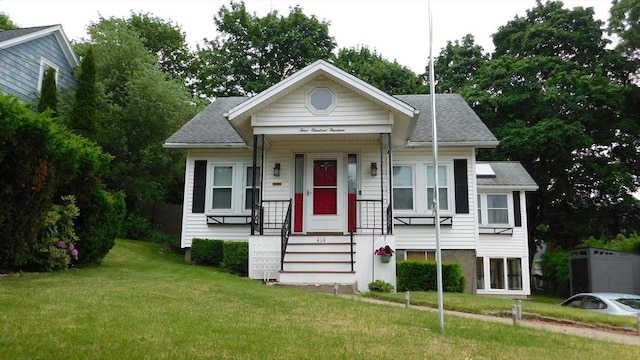 414 Cedar St, Dedham, MA 02026 - bungalow featuring a front yard and roof with shingles