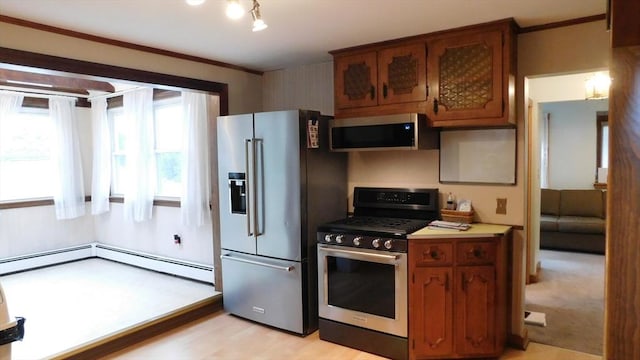 414 Cedar St, Dedham, MA 02026 - kitchen featuring appliances with stainless steel finishes, brown cabinetry, a baseboard heating unit, light countertops, and ornamental molding