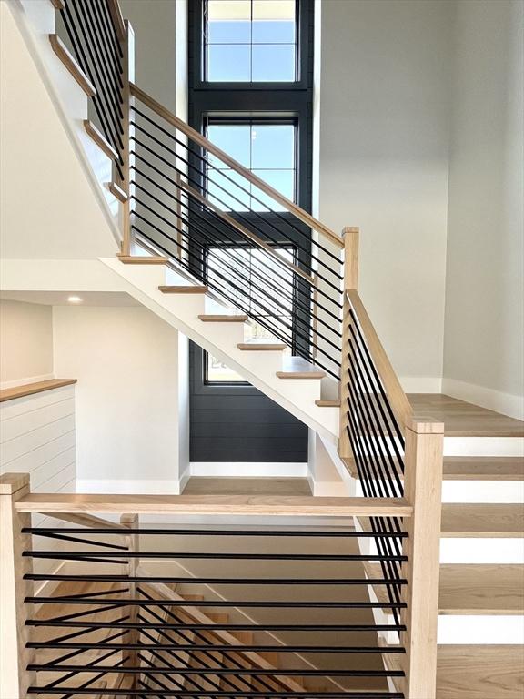 108 Glen St, Natick, MA 01760 - staircase with a towering ceiling and baseboards