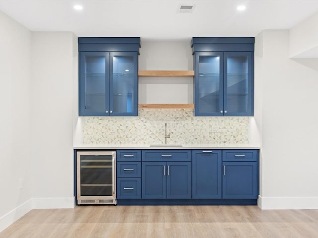 108 Glen St, Natick, MA 01760 - indoor wet bar featuring beverage cooler, light wood-style floors, baseboards, and recessed lighting