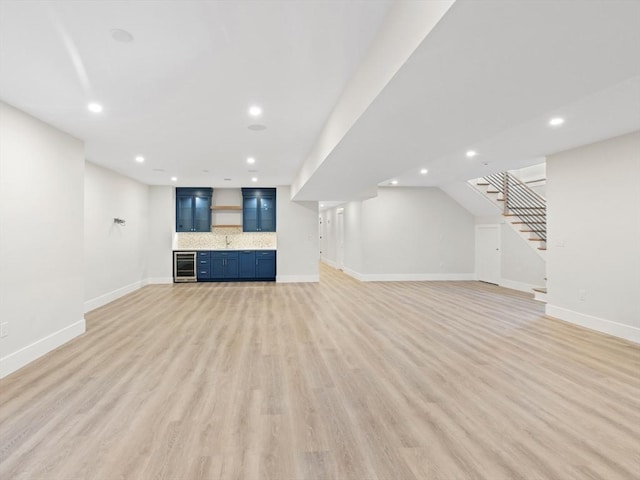 108 Glen St, Natick, MA 01760 - unfurnished living room with stairway, recessed lighting, light wood-style flooring, baseboards, and bar