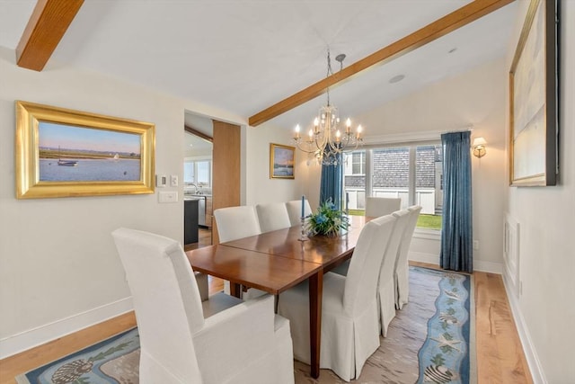 dining room with a chandelier, light wood-type flooring, healthy amount of natural light, and baseboards