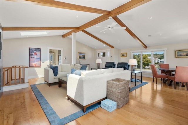living area featuring light wood-style flooring, recessed lighting, ceiling fan, baseboards, and a skylight