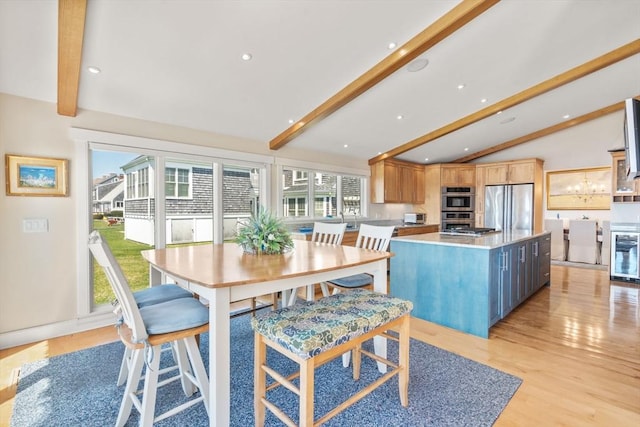 dining space featuring light wood-type flooring, wine cooler, recessed lighting, and a chandelier
