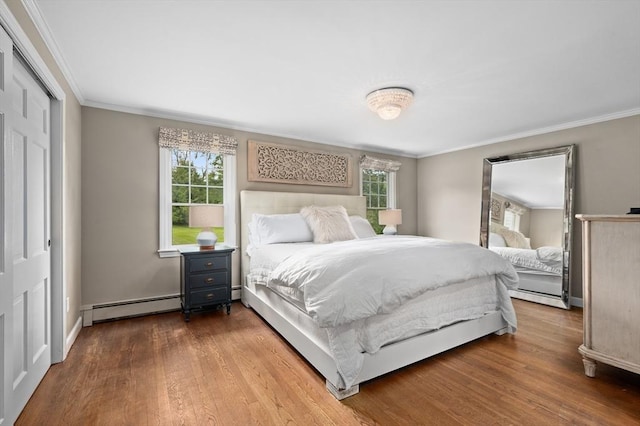 46 Baldpate Rd, Boxford, MA 01921 - bedroom featuring a baseboard radiator, multiple windows, wood finished floors, crown molding, and a closet